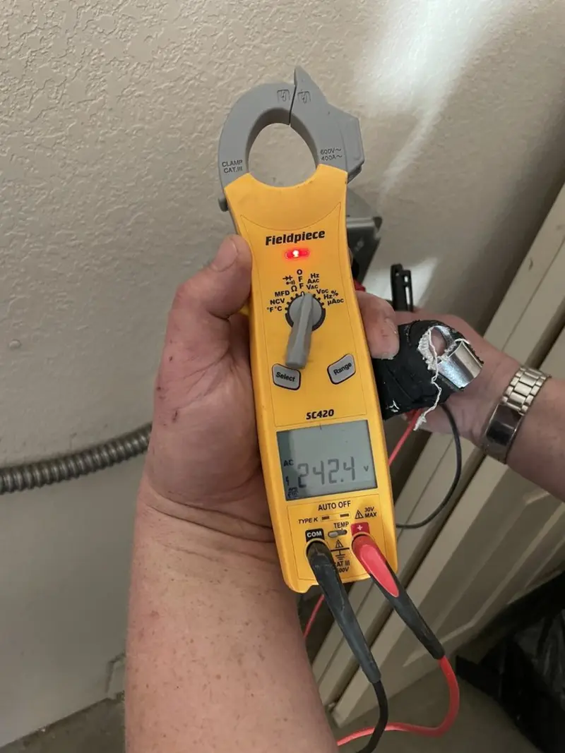 Voltage testing with clamp meter during Ceiling Fan Installation in Hammond